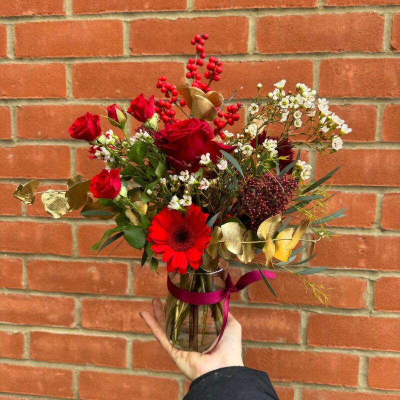 Festive Jam Jar Vase Arrangement packed full of Christmas goodies is the perfect gift. Order online for your next day flower delivery. Bishops Stortford