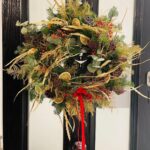 Golden Christmas Wreath. Sprinkled with a gold fern and velvet bow. Order online for your next day flower delivery. Bishops Stortford