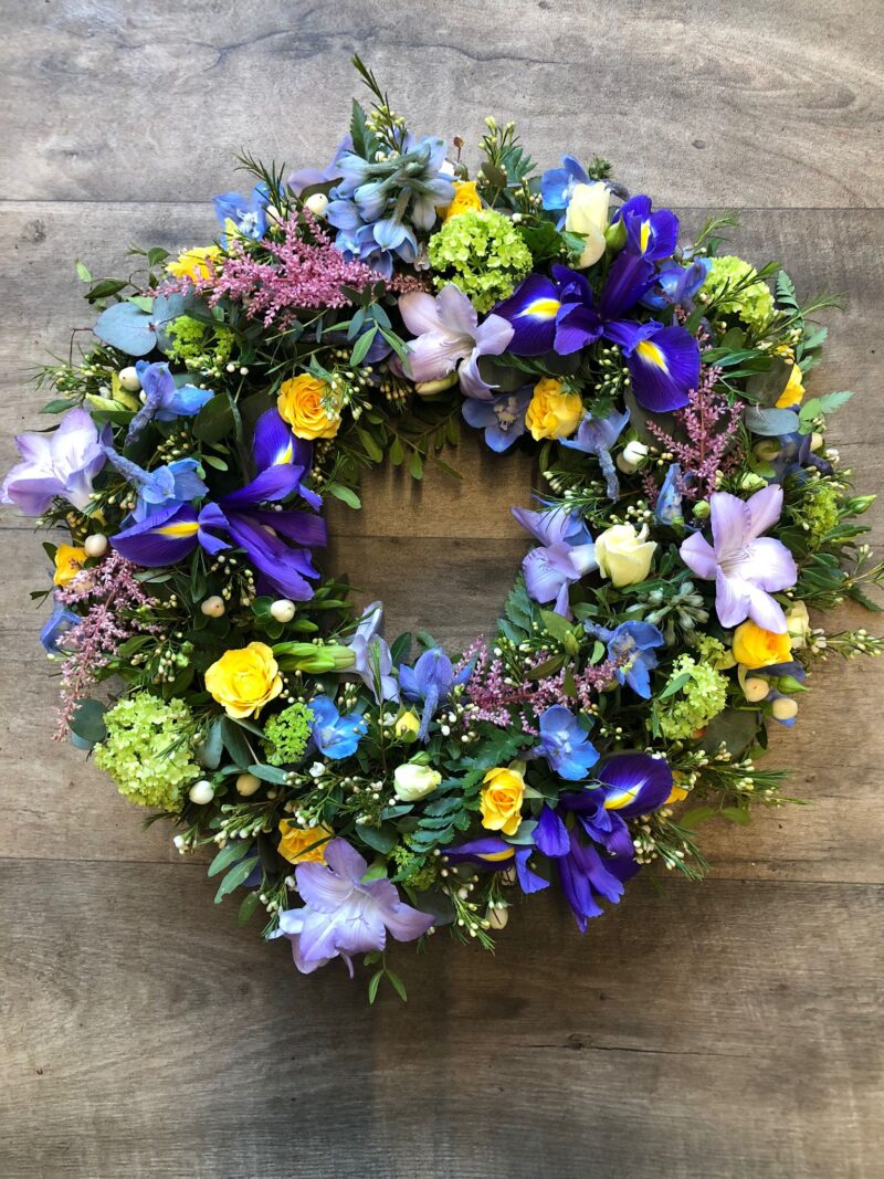 A beautiful Wreath funeral tribute with loose flowers and foliage for your love one. Order online with your personal choices. Bishops Stortford