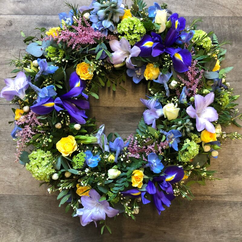 A beautiful Wreath funeral tribute with loose flowers and foliage for your love one. Order online with your personal choices. Bishops Stortford