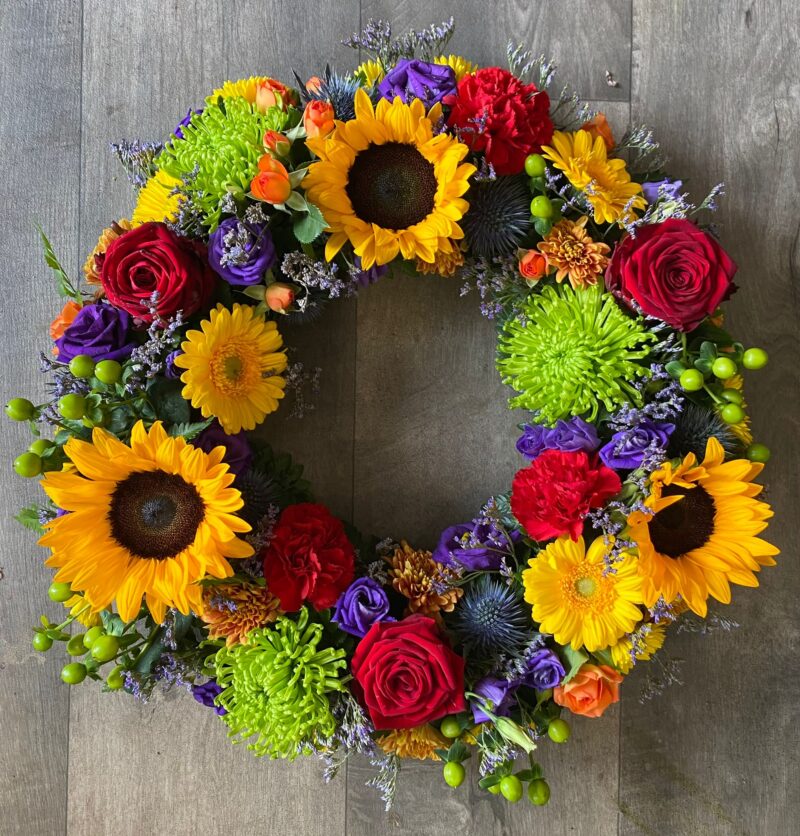 A beautiful Wreath funeral tribute with loose flowers and foliage for your love one. Order online with your personal choices. Bishops Stortford