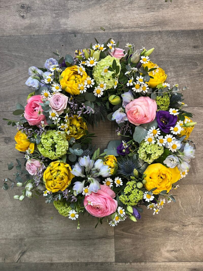 A beautiful Wreath funeral tribute with loose flowers and foliage for your love one. Order online with your personal choices. Bishops Stortford