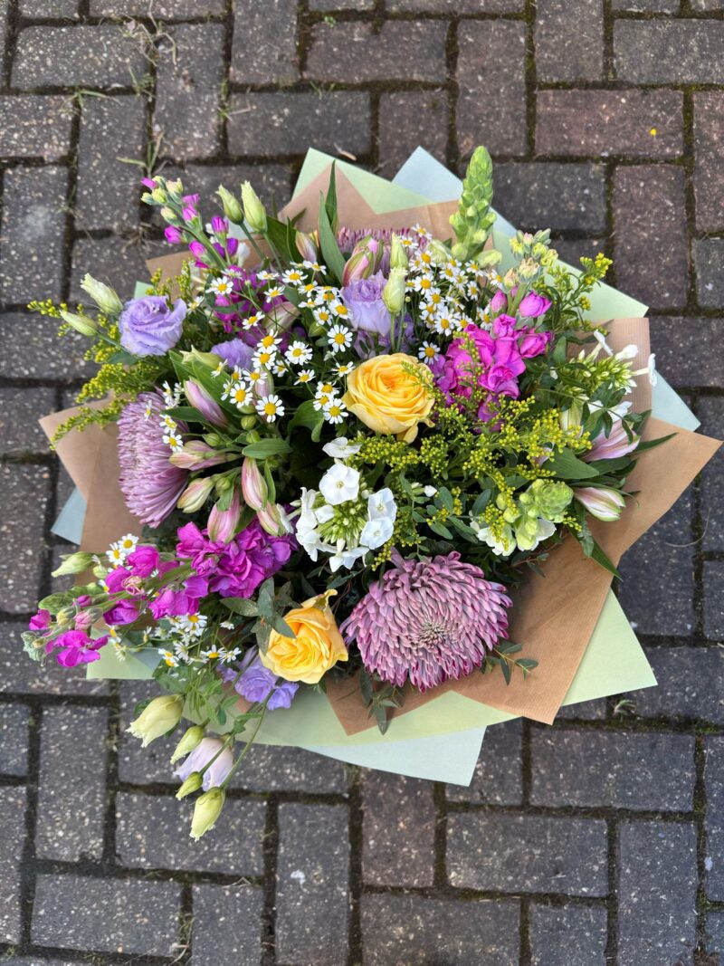 Buttercup Bouquet - a variety of flowers in pastel shades and lush foliage. Order online for your next day flower delivery. Bishops Stortford