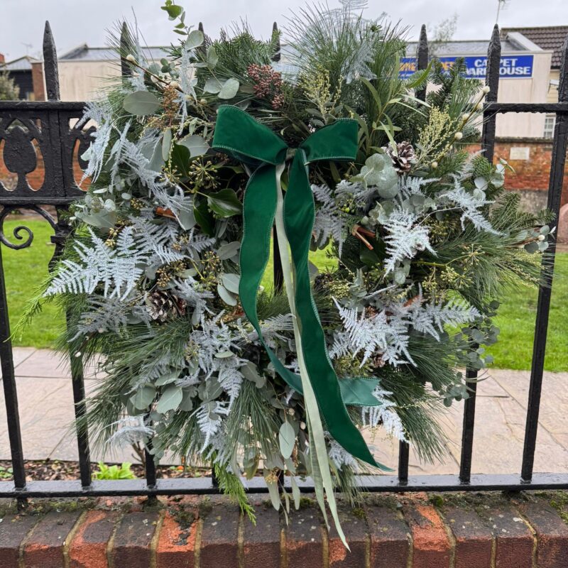 Frost Wreath a lush mix of greenery creating a wintry and festive look. Order online for your next day flower delivery. Bishops Stortford