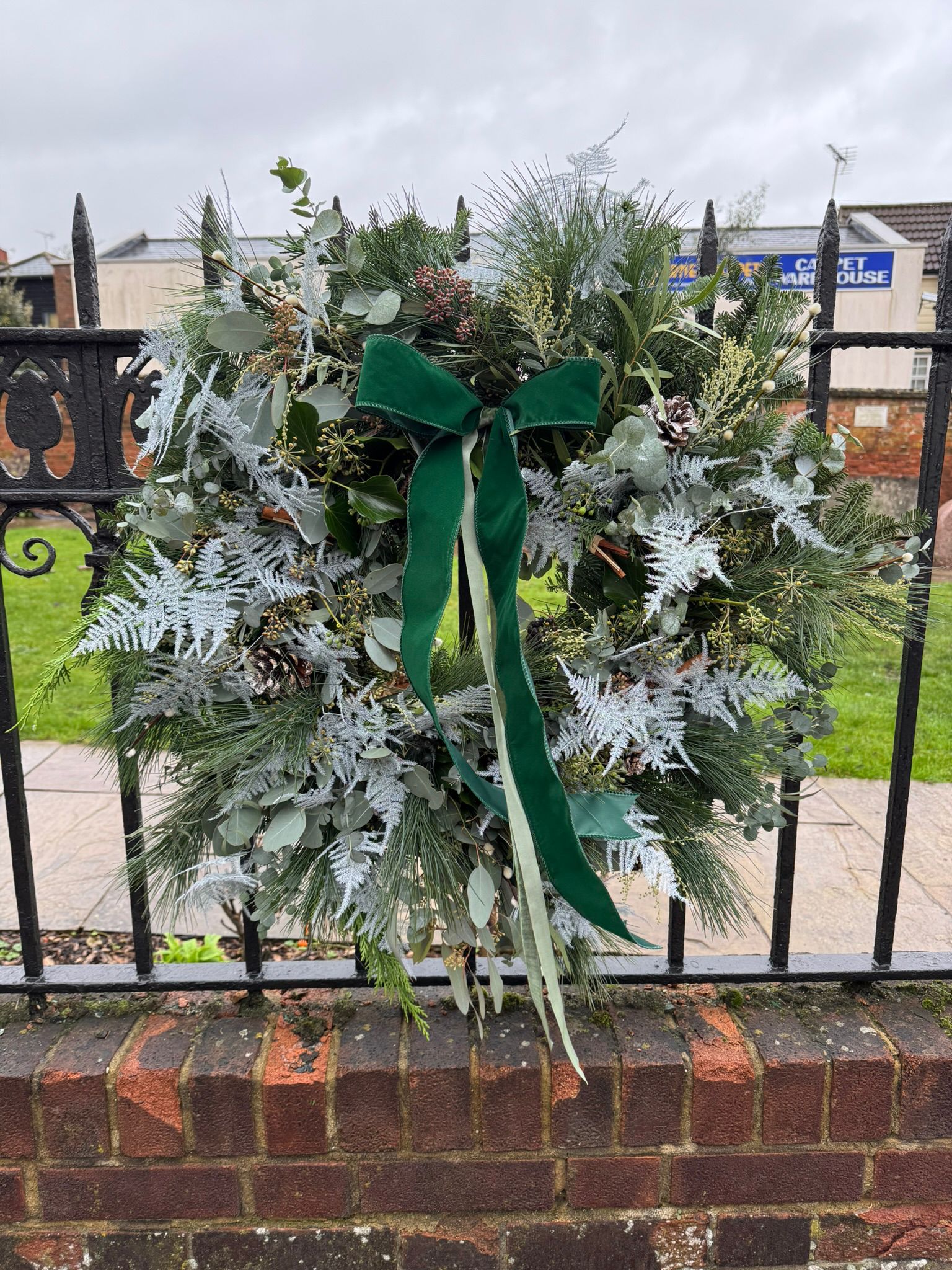 Frost Wreath a lush mix of greenery creating a wintry and festive look. Order online for your next day flower delivery. Bishops Stortford