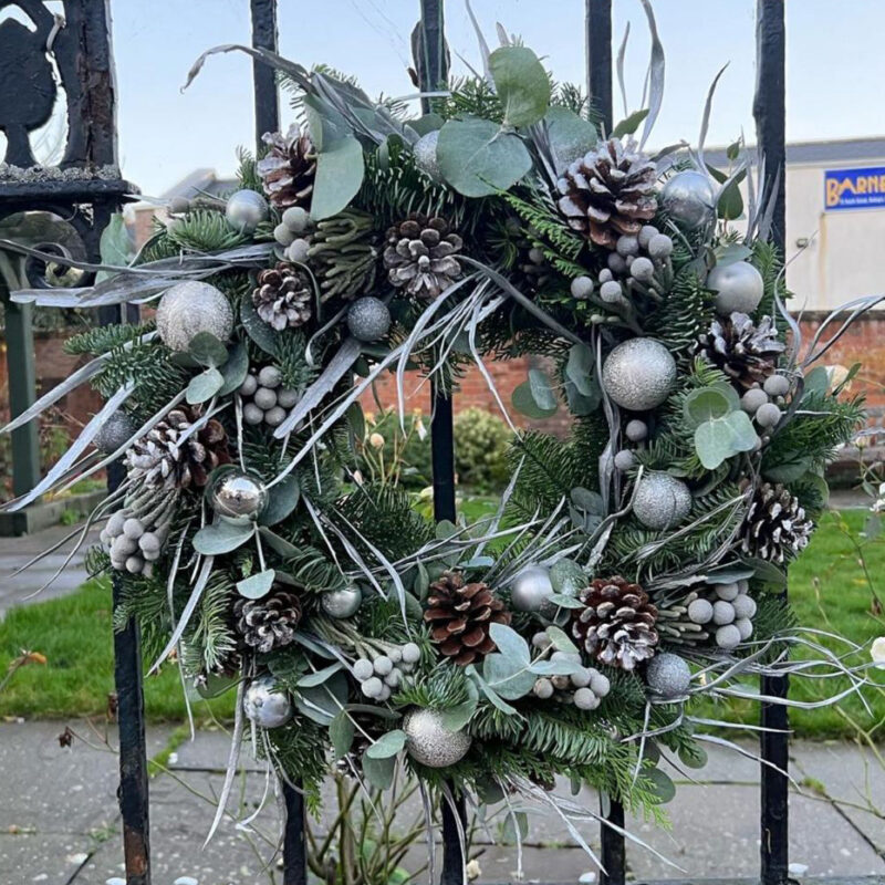 Snowman Wreath full of a wintery mixture of foliages. So much luxury! Order online for your next day flower delivery. Bishops Stortford